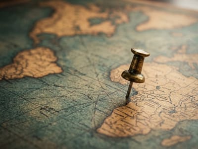 Brass push pin stuck in an antique map near the Gulf of Mexico