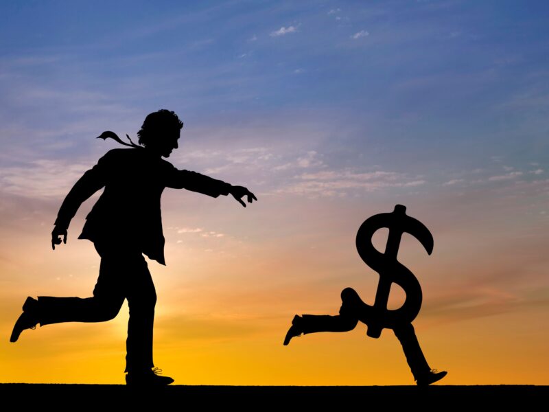 man chasing money